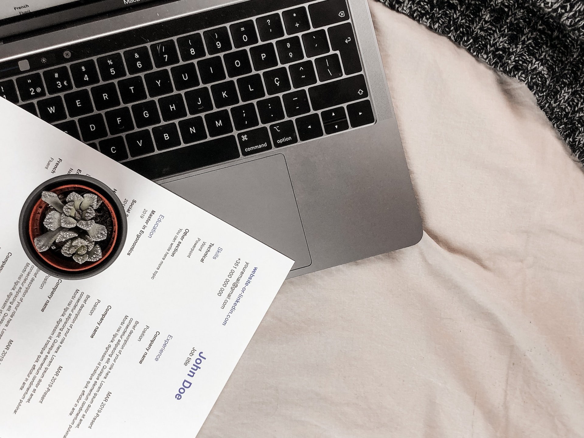 CV next to Laptop